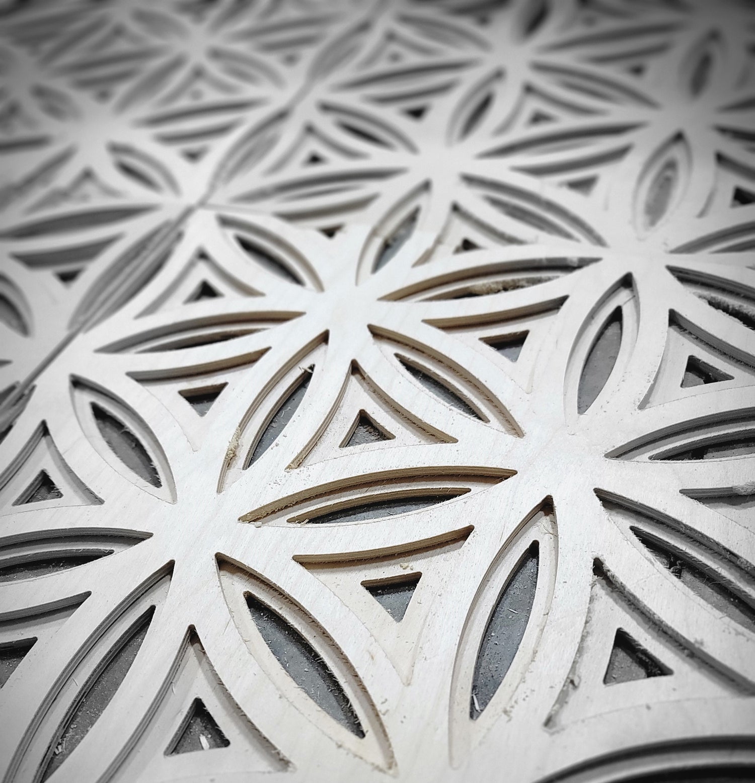 Zoomed in view of wood flower of life cut out