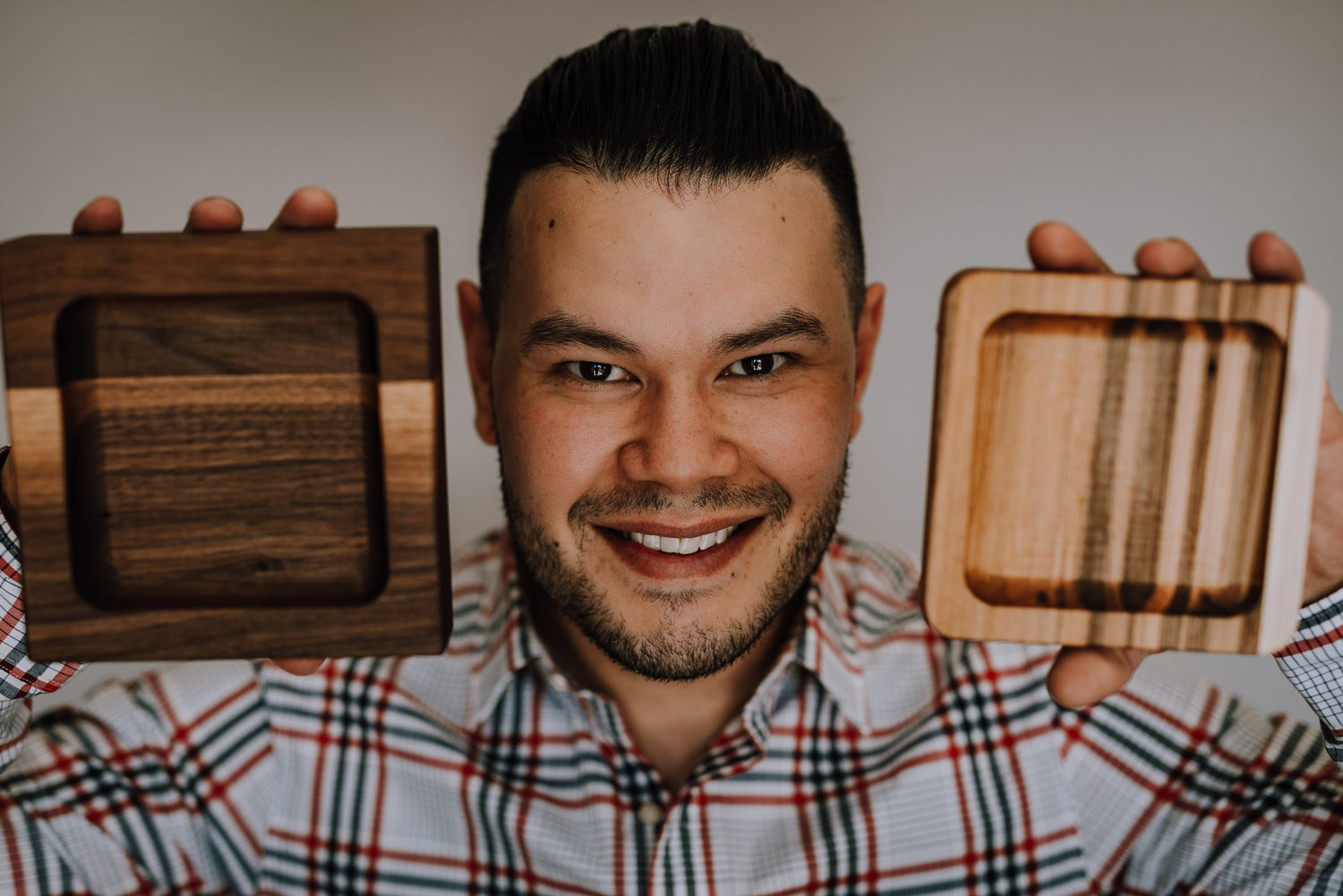 Sam Coleman, the owner, holding wood trays